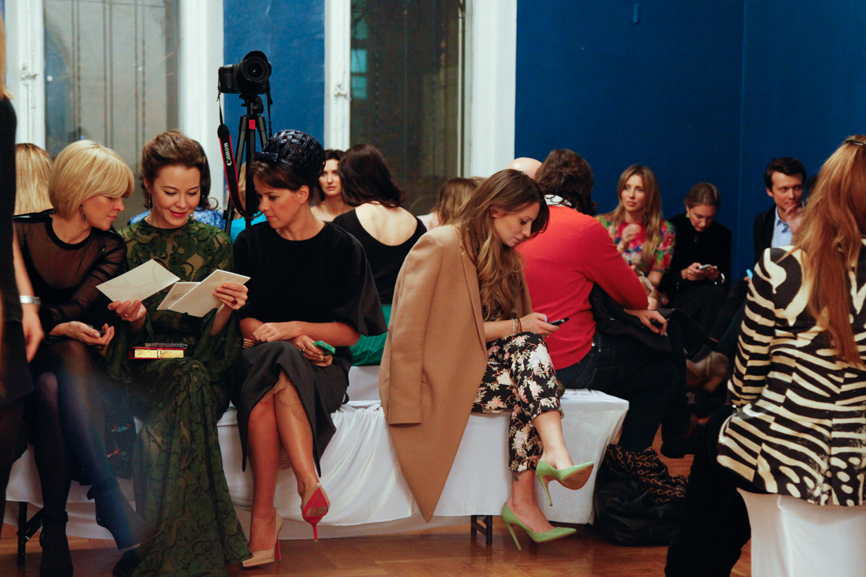 Ulyana Sergeenko looks over invitations and Anastasia Ryabtsova in Celine before Vika Gazinskaya Runway