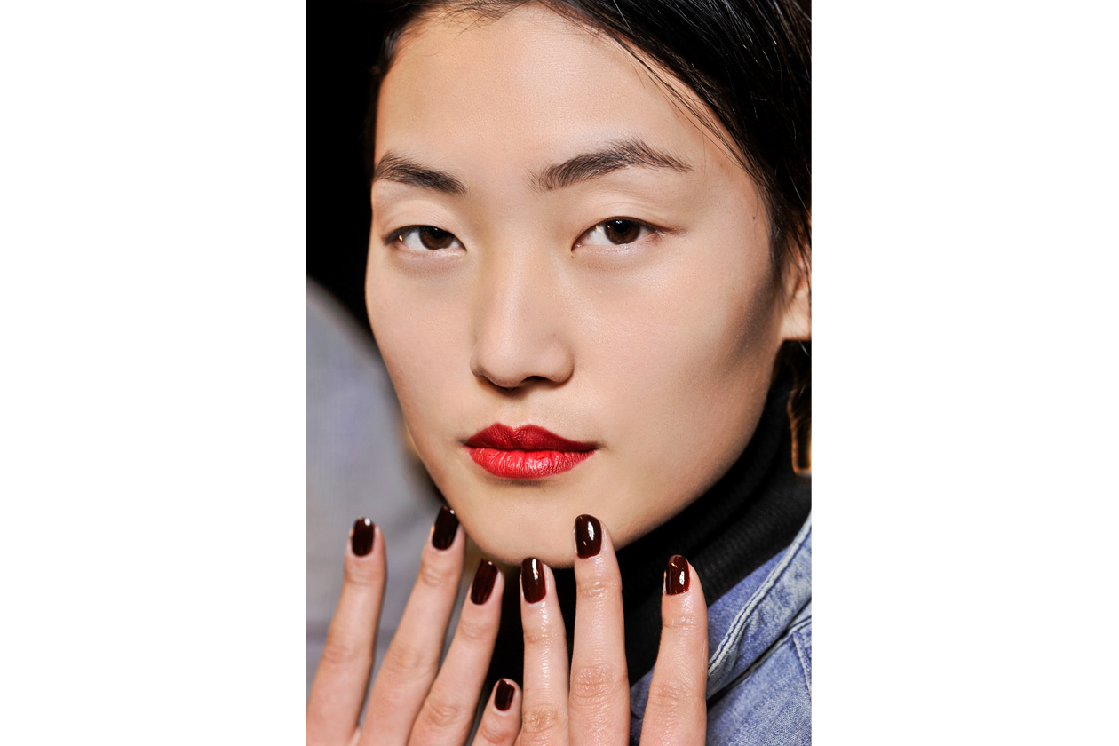Dark brown sulle mani della modella di Tadashi Shoji