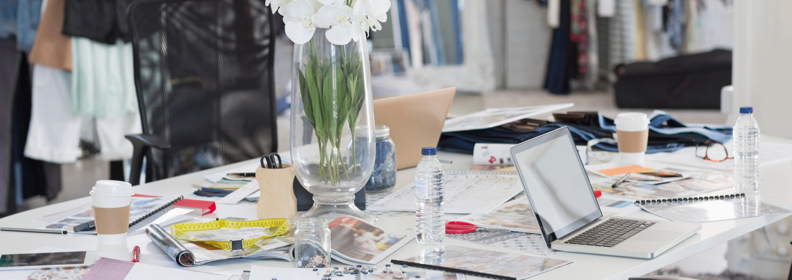 Bouquet, proofs, swatches and clothing in fashion design office. Image shot 2015. Exact date unknown.