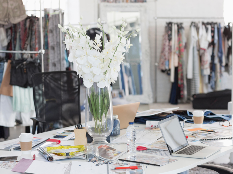 Bouquet, proofs, swatches and clothing in fashion design office. Image shot 2015. Exact date unknown.