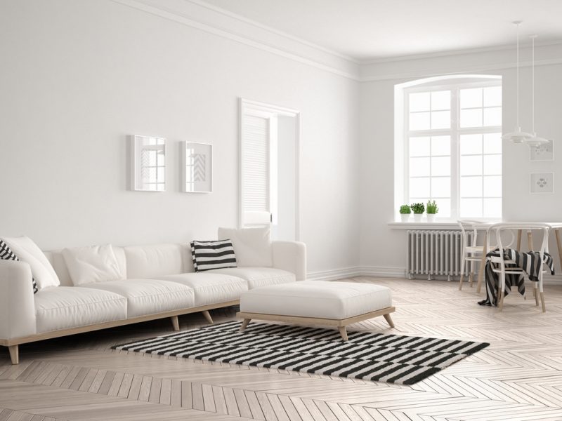 Bright minimalist living room with sofa and dining table, scandinavian white interior design