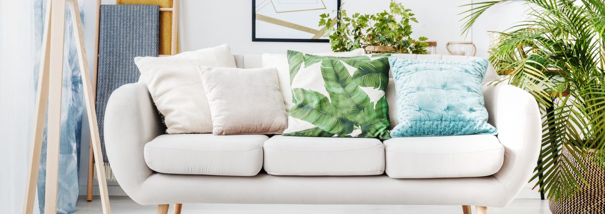 Floral cushion on beige sofa