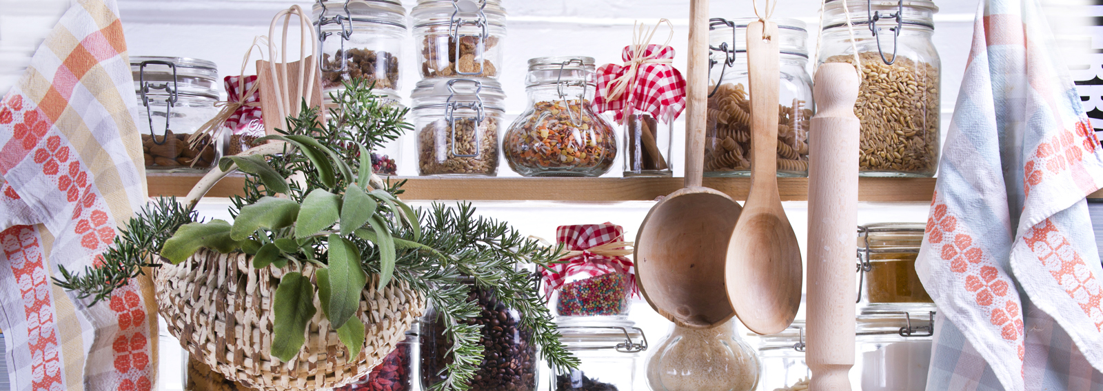 Dried foods stored in glass jars within a small pantry