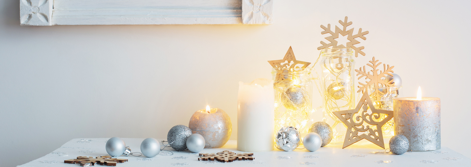 Christmas decoration with candles on background  white wall