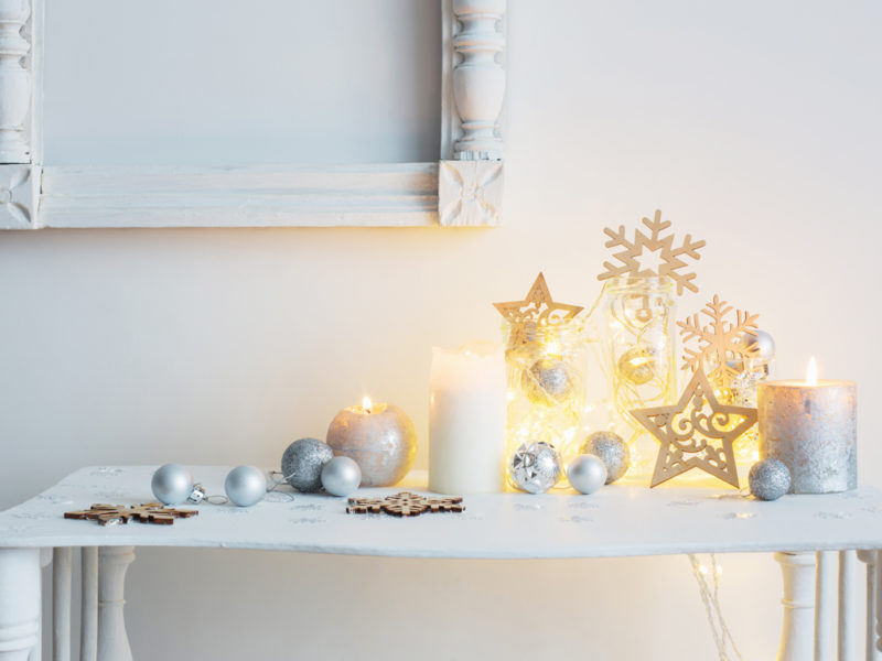 Christmas decoration with candles on background  white wall