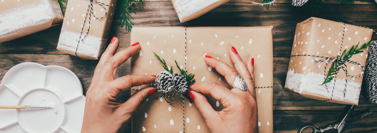 Woman wrapping Christmas presents in a crafty way