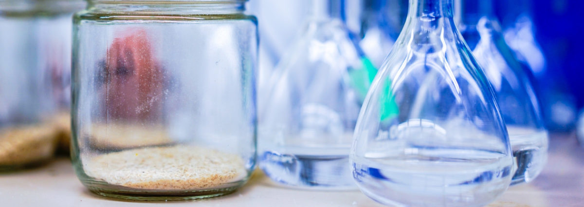 1two-clear-glass-jars-beside-several-flasks-248152