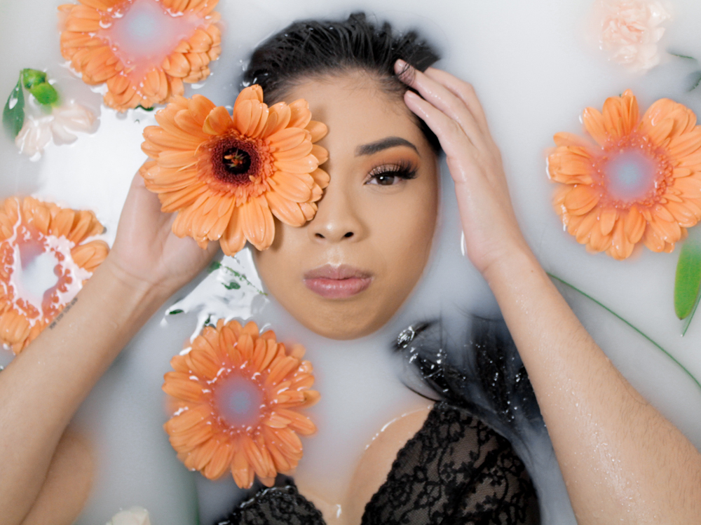 woman-lying-in-bathtub-with-orange-petaled-flowers-3427769