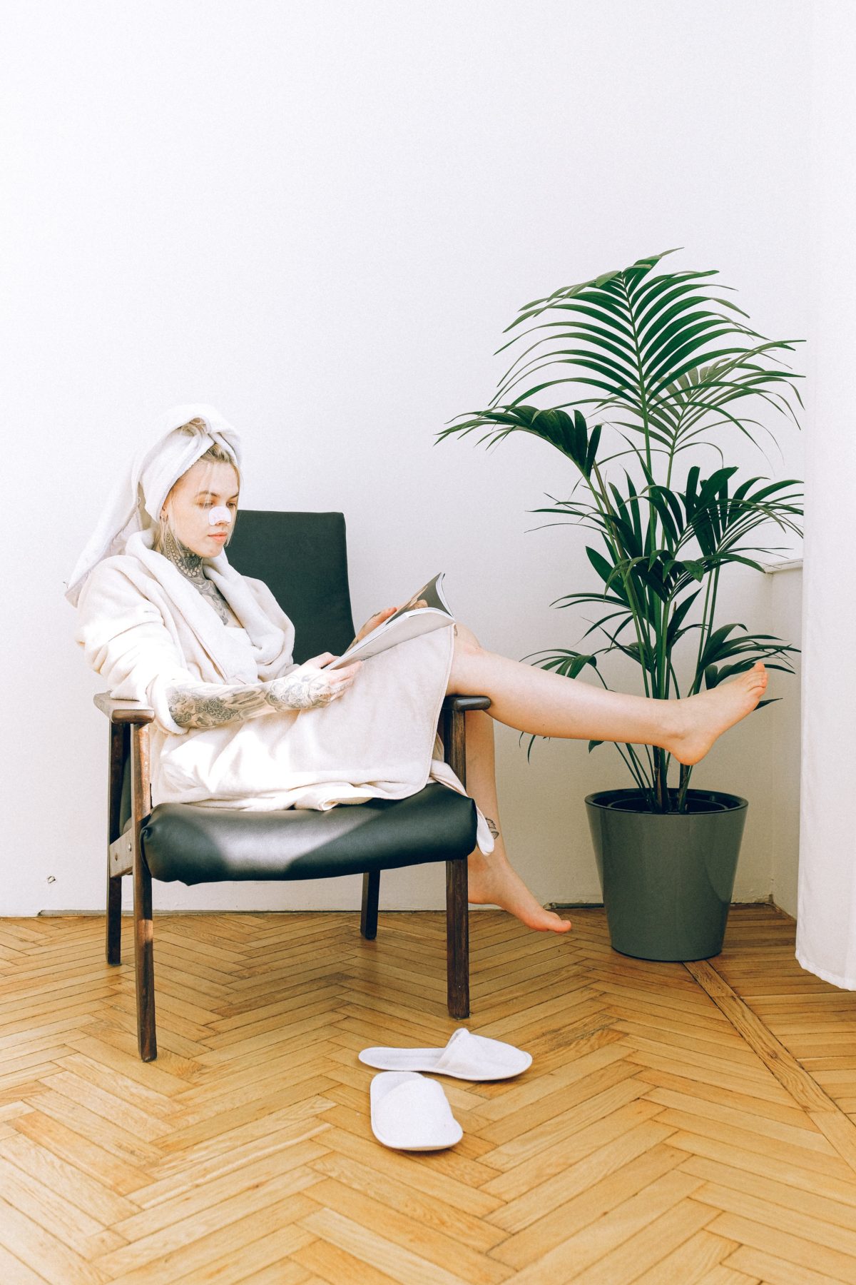 woman-in-white-long-sleeve-shirt-sitting-on-black-chair-3852037