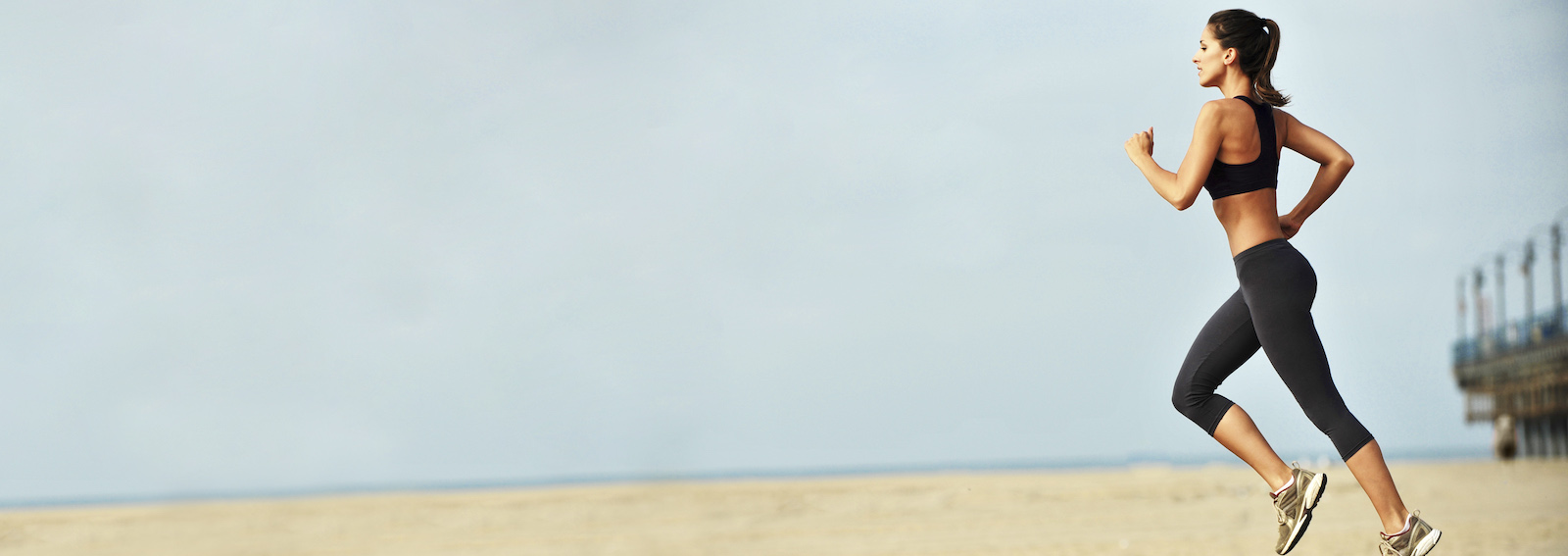 Young Woman Jogging on Boardwalk Santa Monica Beach