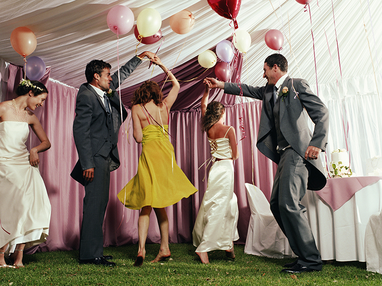 Bridal party dancing in marquee