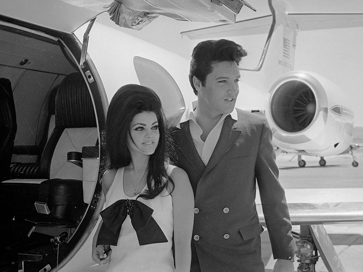 Elvis and Priscilla Presley Posing near Airplane
