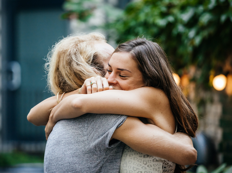 Young Couple Embrace Each Other Lovingly At Barbecue Meetup