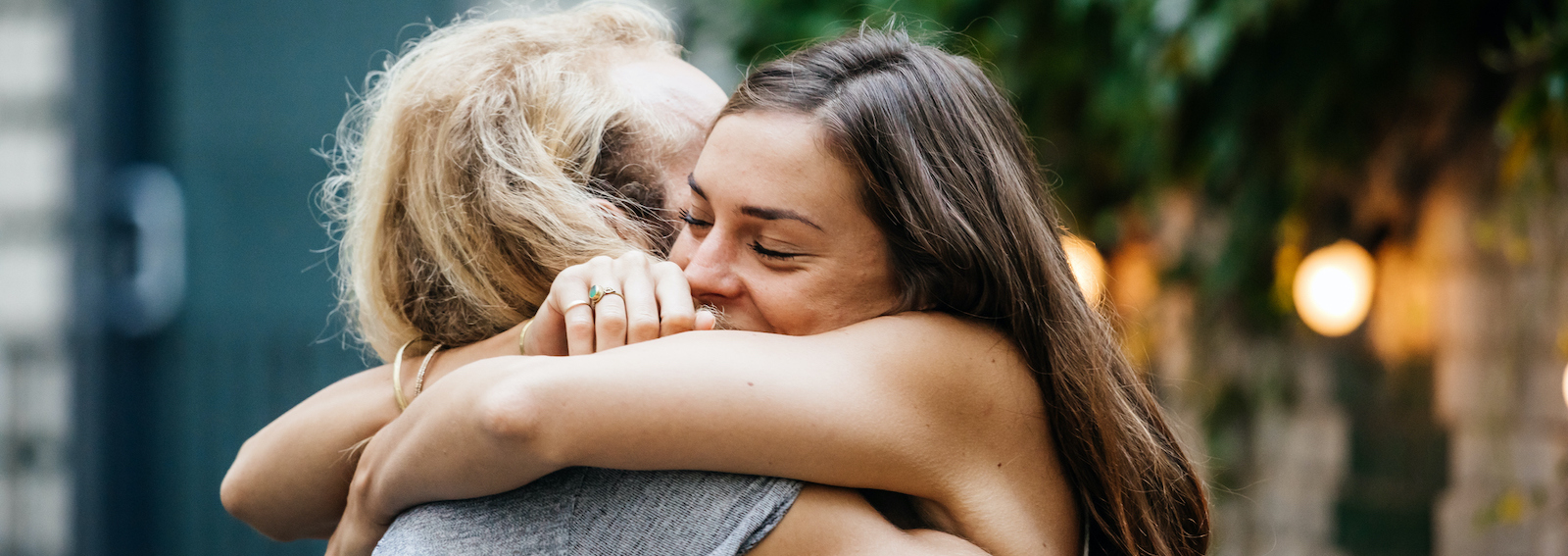 Young Couple Embrace Each Other Lovingly At Barbecue Meetup