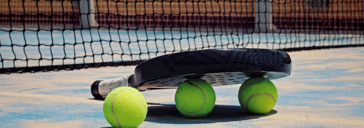 Black Padel racket with balls.