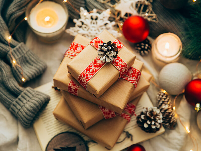 Stack of Christmas gifts, decorations and knitted sweater