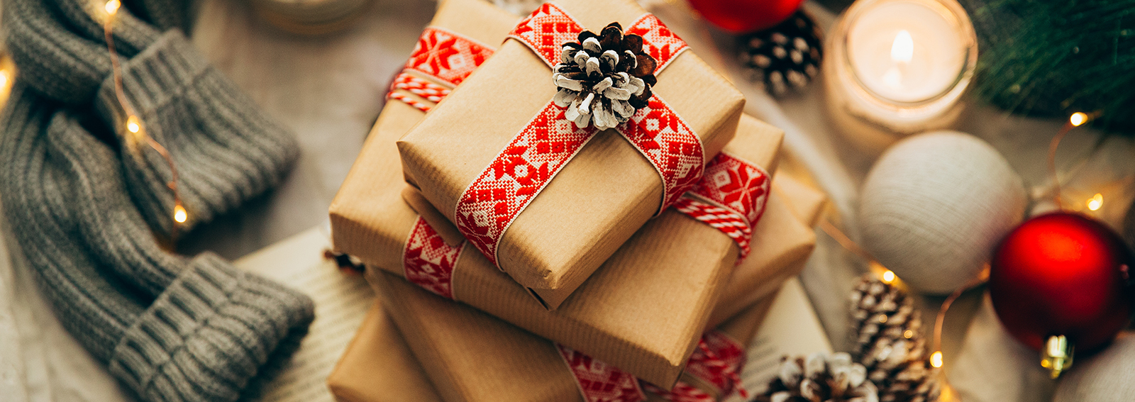 Stack of Christmas gifts, decorations and knitted sweater