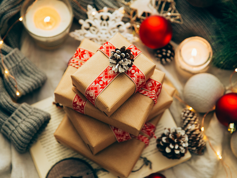 Stack of Christmas gifts, decorations and knitted sweater