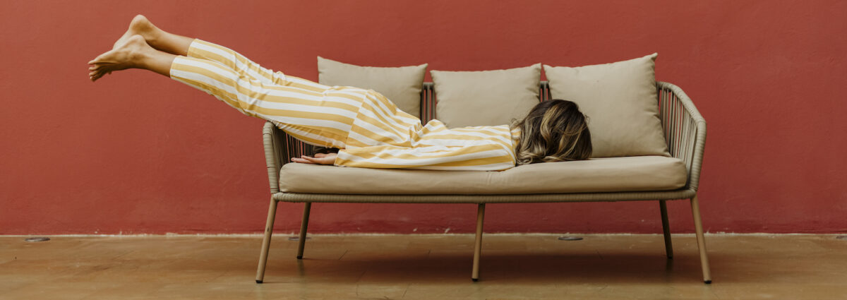 Tired young woman sleeping on sofa