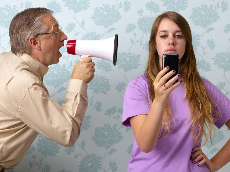 Father shouting at daughter texting