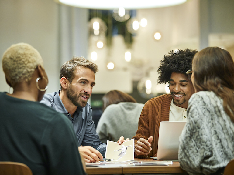 Multi-ethnic coworkers discussing in office