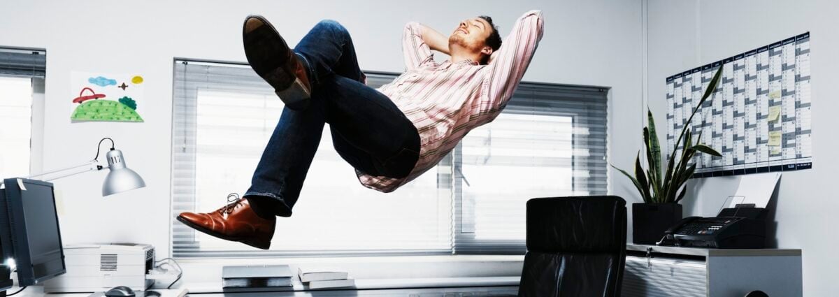 Man Floating in his office.