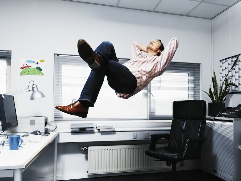 Man Floating in his office.