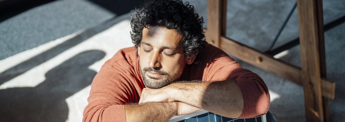 Businessman with solar panel under sunlight in office