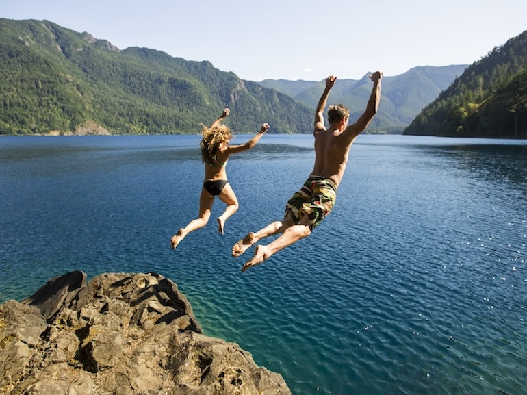 Man and woman cliff jumping