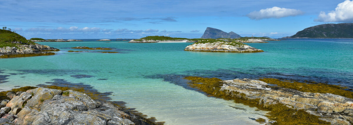 View on sea and mountains in Sommar√∏y, county Troms. Turqouise water color. Beautiful summer day up north.