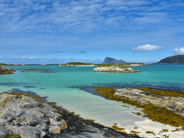 View on sea and mountains in Sommar√∏y, county Troms. Turqouise water color. Beautiful summer day up north.