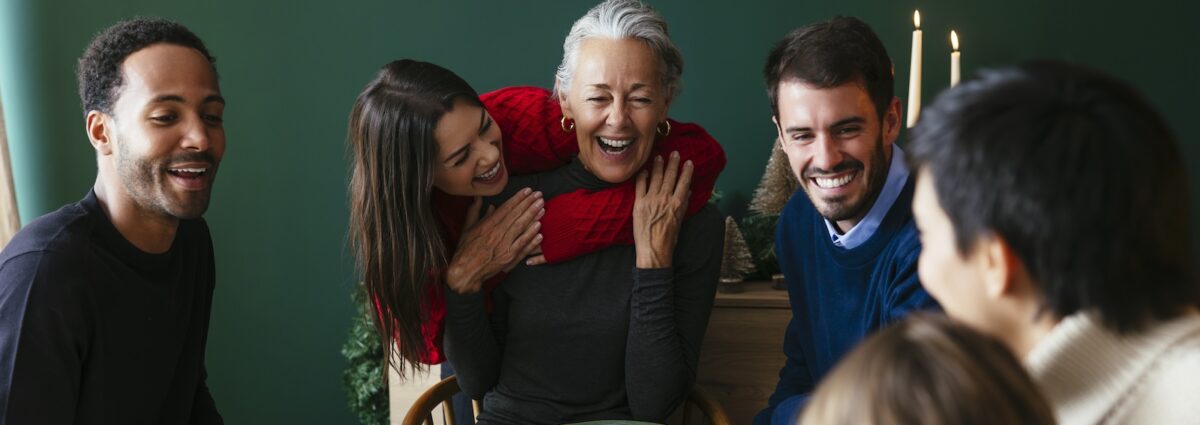 Multiracial family enjoying dinner party on Christmas vacation