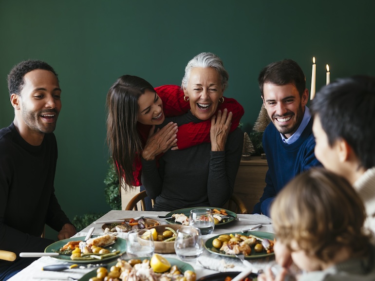 Multiracial family enjoying dinner party on Christmas vacation