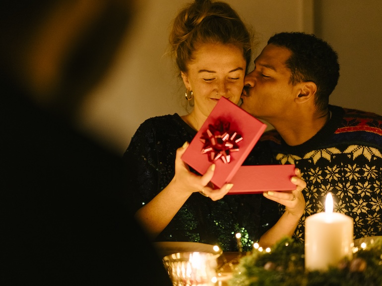 Woman receives presents from her boyfriend at Christmas