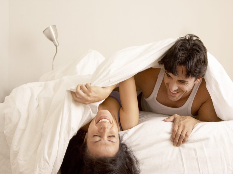 Couple laughing in bed together