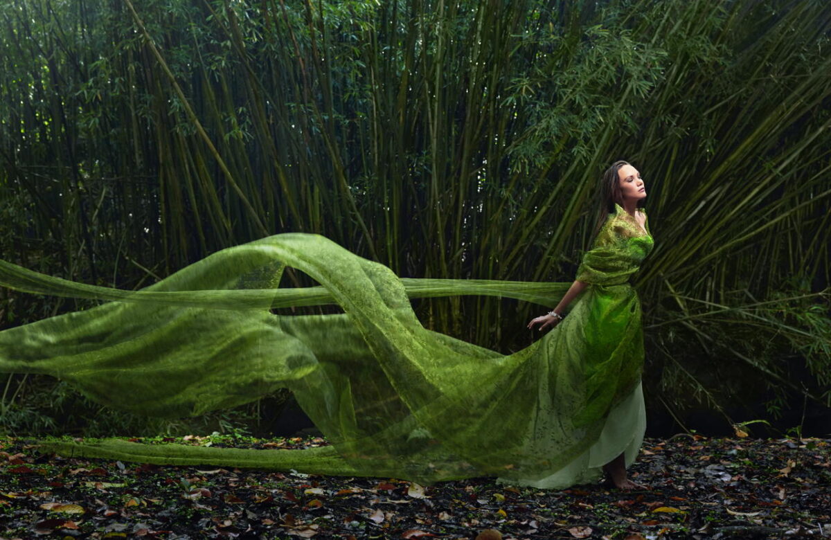Pacific Islander woman in flowing green dress outdoors