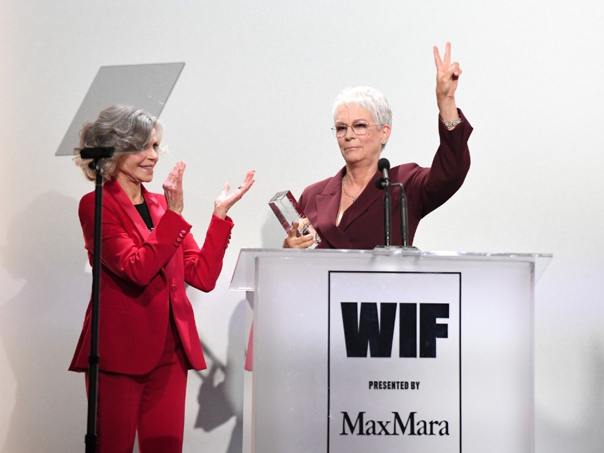 ok Jamie Lee Curtis (R) accepts the Jane Fonda Humanitarian Award from Jane Fonda (L), both wearing Max Mara, onstage during the 2025