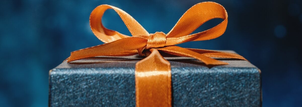 Blue Gift box and orange bow with dark blue background
