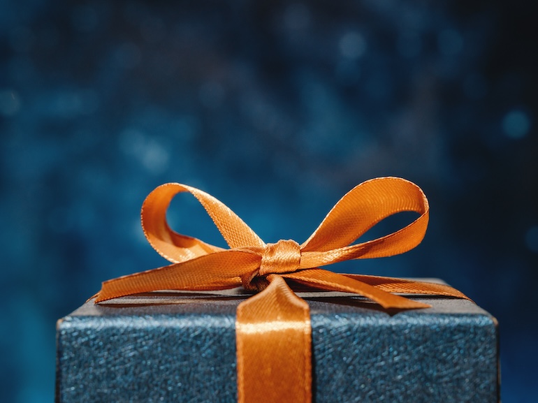 Blue Gift box and orange bow with dark blue background